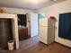 Interior room with tile floors, a refrigerator, and sink, offering simple functionality at 1930 N Murphy St, Pahrump, NV 89060
