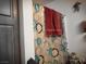 Shower with glass door, decorative shower curtain, and a red towel hanging above it at 1930 N Murphy St, Pahrump, NV 89060
