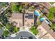 Aerial view of a home with a sparkling pool, solar panels and lush landscaping in a desirable neighborhood at 1978 Kachina Mountain Dr, Henderson, NV 89012