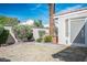 Private backyard oasis with mature landscaping, gravel areas, and a pet door at 1978 Kachina Mountain Dr, Henderson, NV 89012
