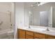 Well-lit bathroom featuring a double vanity and a tiled shower-tub combination at 1978 Kachina Mountain Dr, Henderson, NV 89012