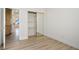 Bedroom with wood-look flooring and a closet with mirrored sliding doors at 1978 Kachina Mountain Dr, Henderson, NV 89012