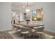 Bright dining room featuring wood floors and a modern table that seats eight at 1978 Kachina Mountain Dr, Henderson, NV 89012