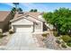 Charming single-story home with a well-manicured front yard and two-car garage in a sunny neighborhood at 1978 Kachina Mountain Dr, Henderson, NV 89012