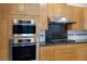 Close-up of the kitchen with stainless steel oven, cooktop, and backsplash at 1978 Kachina Mountain Dr, Henderson, NV 89012