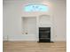 Bright living room featuring a cozy fireplace and modern wood flooring at 1978 Kachina Mountain Dr, Henderson, NV 89012