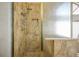 The shower features a glass door with gold trim and bronze-colored tile throughout at 1978 Kachina Mountain Dr, Henderson, NV 89012