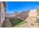 Cozy backyard with decorative rock, seating area, and turf perfect for low-maintenance living at 220 Biscotti Ave # Lot 127, North Las Vegas, NV 89084