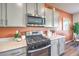 Close-up of kitchen showcasing stainless steel oven, microwave, countertops, and light gray cabinets at 220 Biscotti Ave # Lot 127, North Las Vegas, NV 89084