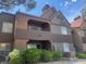 Condo exterior featuring a stucco facade, tiled roof, and well-maintained landscaping at 2200 S Fort Apache Rd # 2113, Las Vegas, NV 89117