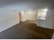 Spacious living room with neutral carpet flowing to the kitchen at 2200 S Fort Apache Rd # 2113, Las Vegas, NV 89117