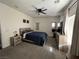 Relaxing bedroom featuring a queen bed, ceiling fan, and neutral color palette for a calming ambiance at 2208 Dale Bumpers Ct, North Las Vegas, NV 89081