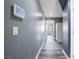 Hallway with a smart home control panel and sleek flooring, offering a glimpse into the adjacent rooms at 2208 Dale Bumpers Ct, North Las Vegas, NV 89081