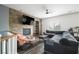 Cozy living room features a stone accent wall with a fireplace and a comfortable gray sectional at 2208 Dale Bumpers Ct, North Las Vegas, NV 89081