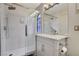 Elegant bathroom with a glass shower and vanity with a stylish mirror at 2224 Lucerne Ct, Henderson, NV 89014
