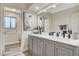 Bathroom with a gray vanity, white quartz countertops, and modern fixtures at 2224 Lucerne Ct, Henderson, NV 89014