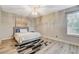 Comfortable bedroom features a cozy bed, stylish light fixture, and a view to the outdoors at 2224 Lucerne Ct, Henderson, NV 89014