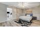 Cozy bedroom with a light fixture, soft rug, and a doorway leading to another room at 2224 Lucerne Ct, Henderson, NV 89014