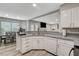 Well-lit kitchen featuring stainless appliances, ample countertop space and seamless view into the dining area at 2224 Lucerne Ct, Henderson, NV 89014