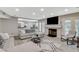 Cozy living room with a fireplace, large windows, and comfortable seating, offering a relaxing atmosphere at 2224 Lucerne Ct, Henderson, NV 89014