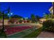 The sport court with basketball hoop provides a recreational space against the backdrop of night lighting at 2224 Lucerne Ct, Henderson, NV 89014