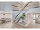 Elegant staircase with modern railings and stylish flooring creates a grand entrance in this home at 2224 Lucerne Ct, Henderson, NV 89014
