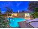 Beautiful backyard with a sparkling pool, lounge chairs, covered patio, and lush landscaping for ultimate relaxation at 2231 Marlboro Dr, Henderson, NV 89014