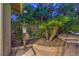 Charming outdoor bath house area with lush greenery, tropical palms, and a relaxing lounge area by the pool at 2231 Marlboro Dr, Henderson, NV 89014
