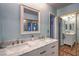 Bathroom featuring a double vanity with marble countertop and modern fixtures at 2231 Marlboro Dr, Henderson, NV 89014