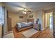 Bedroom with laminate floors, ceiling fan, and a gray accent bench at 2231 Marlboro Dr, Henderson, NV 89014