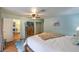 Light-filled bedroom with a ceiling fan, wood dresser, and sliding closet doors at 2231 Marlboro Dr, Henderson, NV 89014
