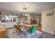 Open-concept dining room with mid-century modern furniture, leading to the kitchen and living spaces at 2231 Marlboro Dr, Henderson, NV 89014