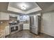 Updated kitchen featuring stainless steel appliances, granite countertops, and stylish marbled flooring at 2231 Marlboro Dr, Henderson, NV 89014