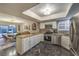 Open-concept kitchen with stainless steel appliances, granite countertops, and adjacent dining area at 2231 Marlboro Dr, Henderson, NV 89014