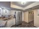 Well-lit kitchen featuring stainless steel appliances, granite countertops, and unique marbled flooring at 2231 Marlboro Dr, Henderson, NV 89014