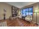 Bright living room sitting area featuring a cozy stone fireplace and lots of natural light at 2231 Marlboro Dr, Henderson, NV 89014