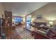 Spacious living room featuring a stone fireplace, hardwood floors, and comfortable leather seating at 2231 Marlboro Dr, Henderson, NV 89014
