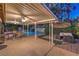 Inviting covered patio features a dining area, outdoor seating, and views of the pool and landscaped yard at 2231 Marlboro Dr, Henderson, NV 89014