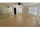 Bedroom features tiled floors, a ceiling fan, and natural light from a large window at 2480 Domingo St, Las Vegas, NV 89121