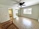 Bright bedroom with tile floors, a ceiling fan, sliding glass closet doors, and natural light at 2480 Domingo St, Las Vegas, NV 89121