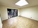 Bonus room featuring tile flooring, skylight, and view of enclosed patio with rock feature at 2480 Domingo St, Las Vegas, NV 89121