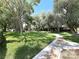 Lush green common area with mature trees and a winding walkway at 2480 Domingo St, Las Vegas, NV 89121
