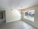 Bright dining room features tiled floors, a chandelier, and natural light from a large window at 2480 Domingo St, Las Vegas, NV 89121