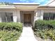 Front entrance with a decorative security door, surrounded by desert landscaping, and mature shrubbery at 2480 Domingo St, Las Vegas, NV 89121