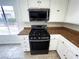 Updated eat in kitchen offers white cabinetry, stone countertops and stainless steel appliances at 2480 Domingo St, Las Vegas, NV 89121