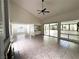 Bright living room features a ceiling fan and tiled flooring with lots of natural light at 2480 Domingo St, Las Vegas, NV 89121