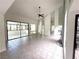 Spacious living room featuring tile floors, clerestory windows, and glass doors to an enclosed patio at 2480 Domingo St, Las Vegas, NV 89121