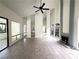 Bright living room features a ceiling fan and high ceilings with mirrored accents at 2480 Domingo St, Las Vegas, NV 89121