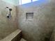 Shower featuring neutral tile, seating and shower head at 2480 Domingo St, Las Vegas, NV 89121