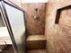 Shower featuring neutral tile, seating and shower head at 2480 Domingo St, Las Vegas, NV 89121